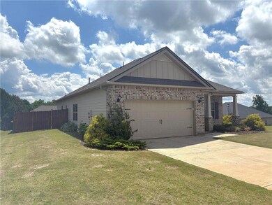 View of side of home featuring brick siding, an at
