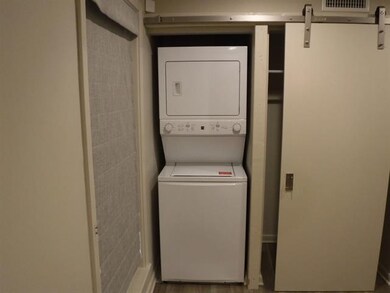 Laundry area featuring stacked washer and clothes dryer