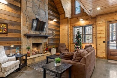 Living room with high vaulted ceiling, a fireplace