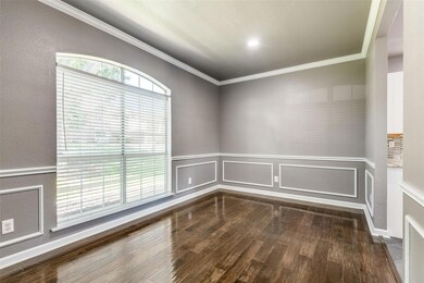Spare room featuring dark hardwood / wood-style flooring and ornamental molding