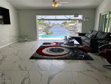 Living room with ceiling fan and a water view