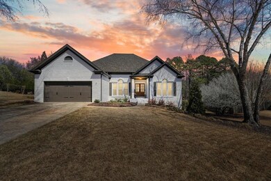 French country inspired facade with a lawn, a gara
