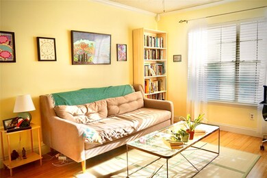 Living area featuring ornamental molding and wood finished floors