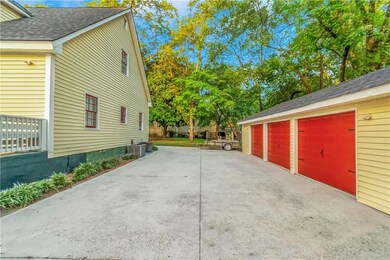 View of property featuring circle driveway, 3 car 