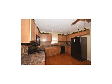 Updated kitchen with tile backsplash, wood floors,