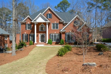 Two Story Brick Home on beautifully landscaped front yard and fenced in backyard professional lawn with sprinklers and beautiful shrubs, trees and islands