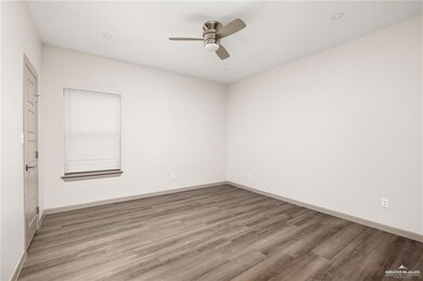 Unfurnished room with light wood-style flooring, ceiling fan, and baseboards