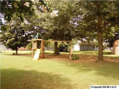 VIEW OF THE BACKYARD-GREAT PLAYSET CAN STAY OR GO! MATURE YARD WITH BEAUTIFUL TREES AND FLOWERS.