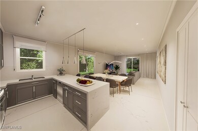 Kitchen with gray cabinetry, open floor plan, stai