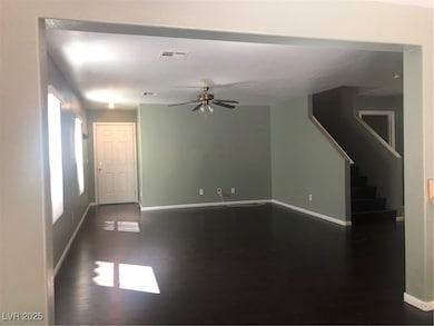 Unfurnished living room featuring a ceiling fan, b
