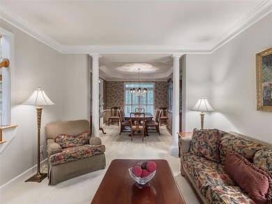 Living room featuring ornate columns, carpet floor
