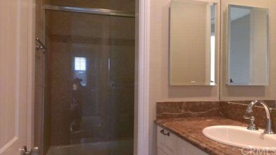 Hallway bathroom with Granite counter and tiled ba