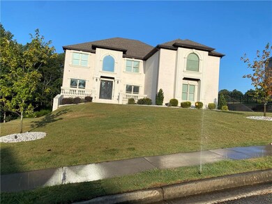 View of front of house featuring a front yard and stucco siding