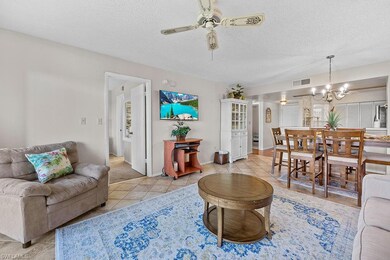 Tiled living room featuring ceiling fan with notab