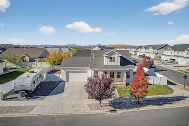 View of front of home with a porch, concrete driveway, a residential view, a garage, and a shingled roof