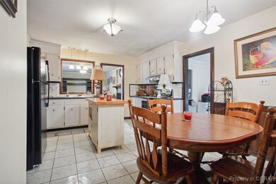 Dining area featuring sink, light tile patterned f