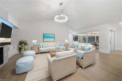 Living room with a chandelier, lofted ceiling, and