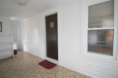 Step from enclosed front porch into a welcoming li