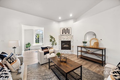 Living area featuring wood finished floors, a fireplace, and recessed lighting
