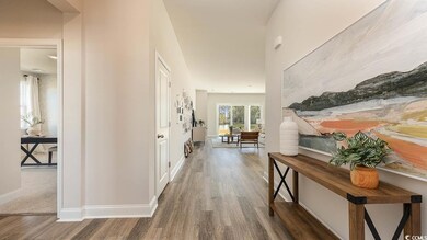Corridor featuring baseboards and wood finished fl