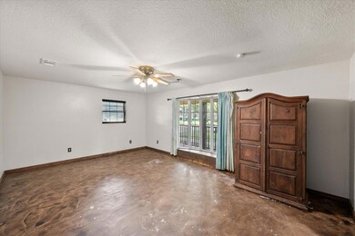 Unfurnished bedroom featuring a textured ceiling a