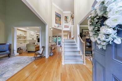 Two story foyer welcomes guests and opens to Dinin