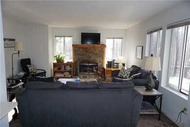 That stone faced wood burning fireplace is the cen