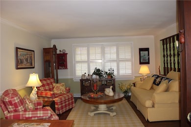 The Living Room has custom plantation shutters and oak planked flooring.