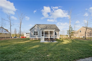 Back of house with crawl space, a yard, a sunroom,