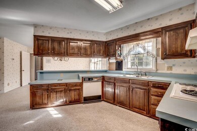 Kitchen featuring sink, white appliances, and ligh