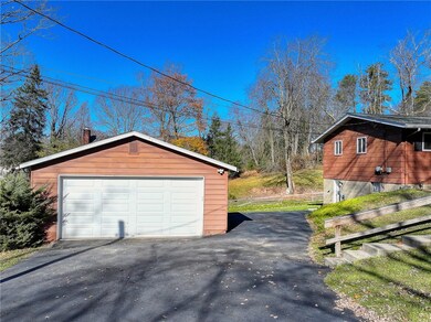 2 car garage with new garage door and asphalt driv