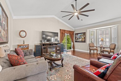 Living room featuring ceiling fan, hardwood / wood