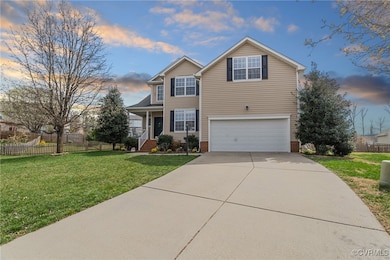Traditional home featuring a lawn, driveway, an at