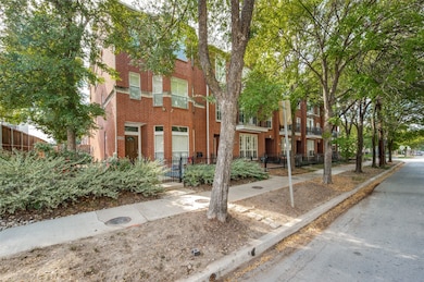 View of front of house with a fenced front yard and brick siding