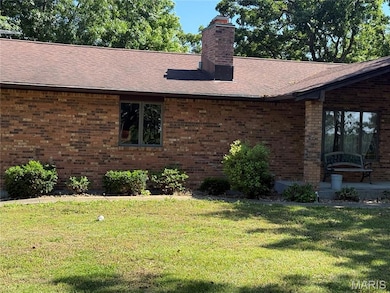 View of property exterior with brick