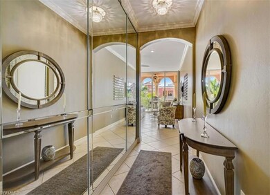 Tiled foyer entrance with crown molding