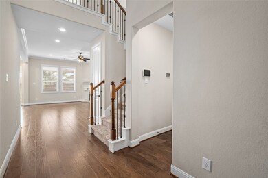 The home's entryway with hardwood floors lead to a