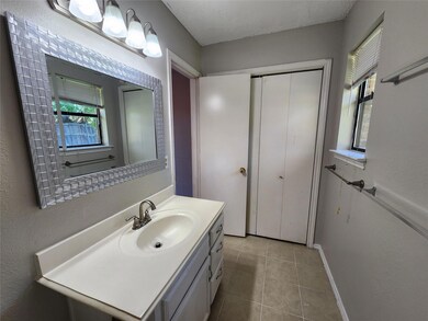 Bathroom featuring tile patterned floors, vanity, and a textured ceiling