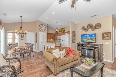Living area featuring a glass covered fireplace, v