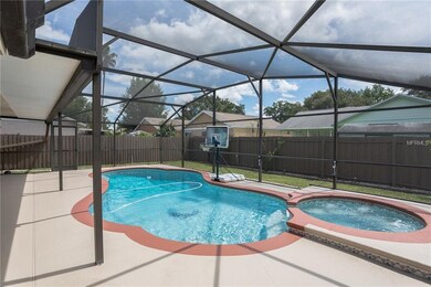 pool/spa with screened enclosure and fenced backya