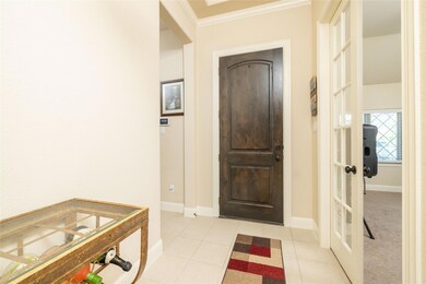 Entrance foyer with ornamental molding, french doo