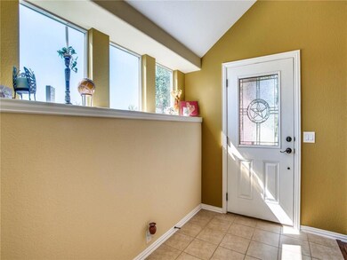 Windows along entry provide warm natural light for