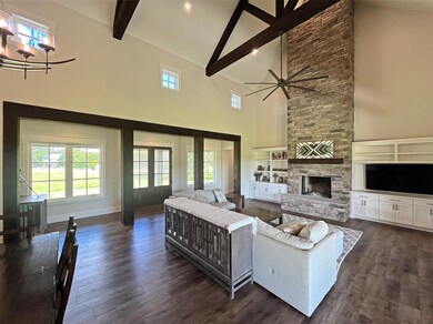 Living area featuring high vaulted ceiling, beame