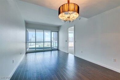 Spare room featuring baseboards, a chandelier, and
