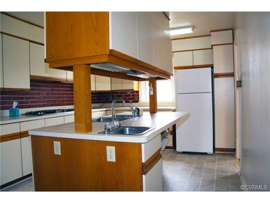 Kitchen with center island.  Two refrigerators, ga