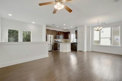 Unfurnished living room featuring a chandelier, b