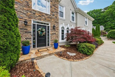 Doorway to property featuring stone siding and stu