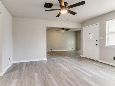 Foyer entrance featuring ceiling fan and light har