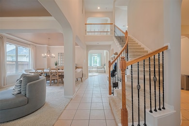 Elegant foyer with soaring ceilings, inviting stai