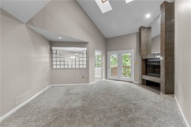 Main floor family room with marble fireplace surro